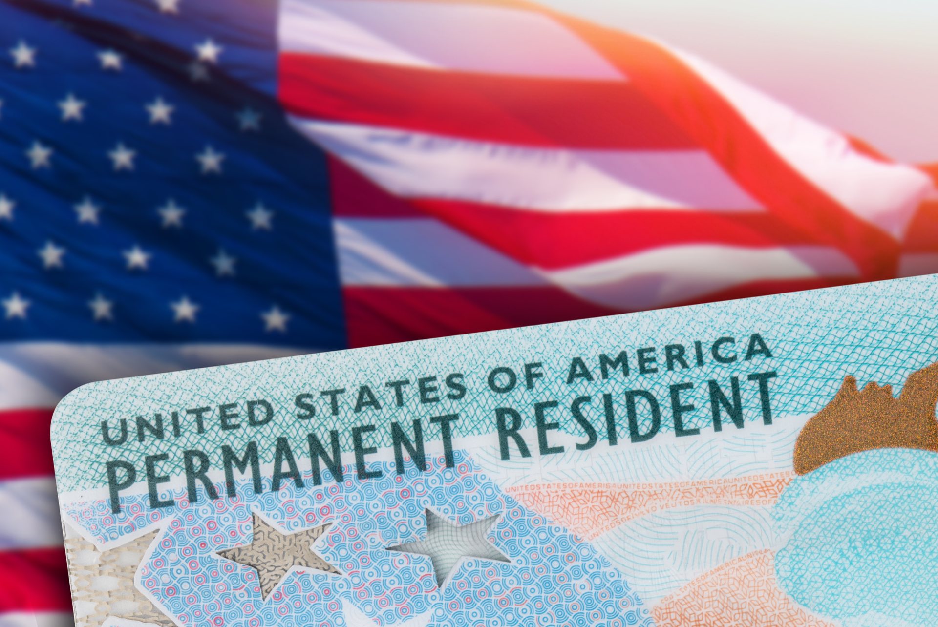 Green card on top of an american flag