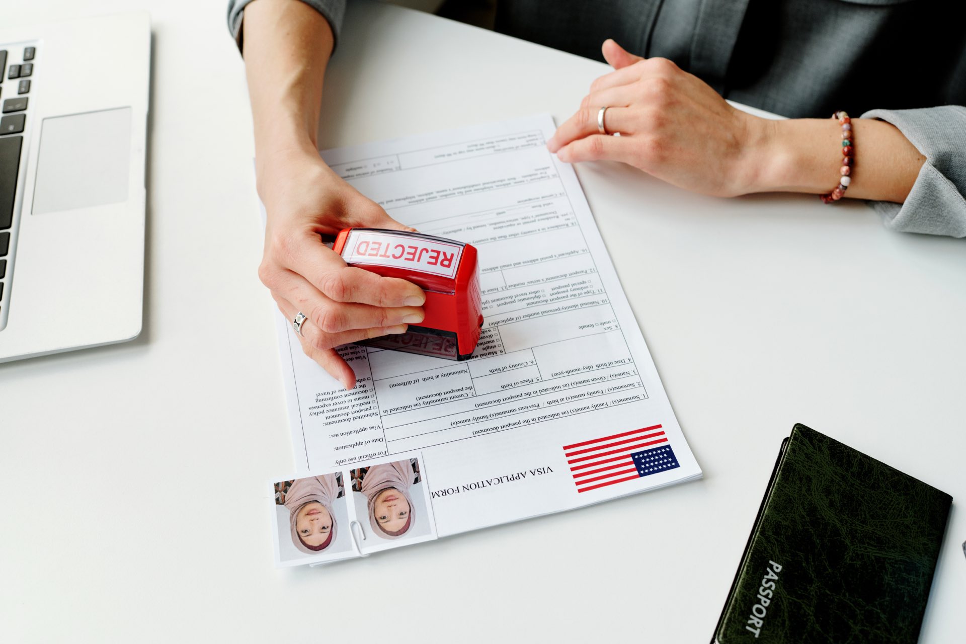 Person holding a stamp that says rejected and stamping a paper