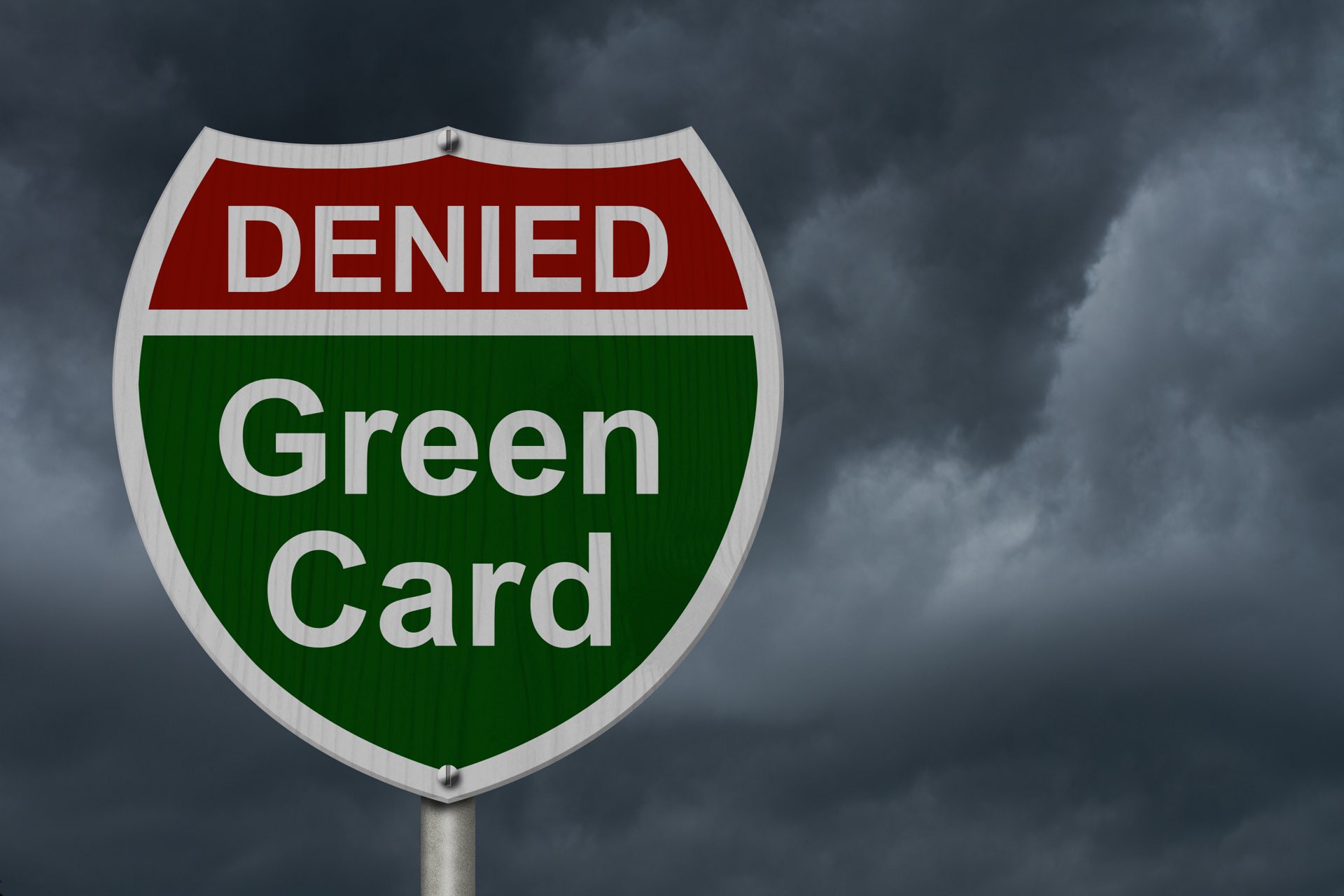 Black sky background with a sign that says denied in red and green card in green