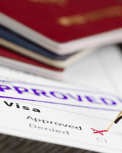 Visa form close up, fountain pen and approved stamped on a document.